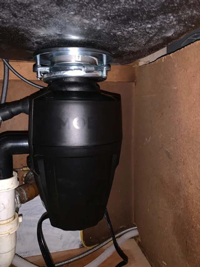 Garbage disposal installed below a sink